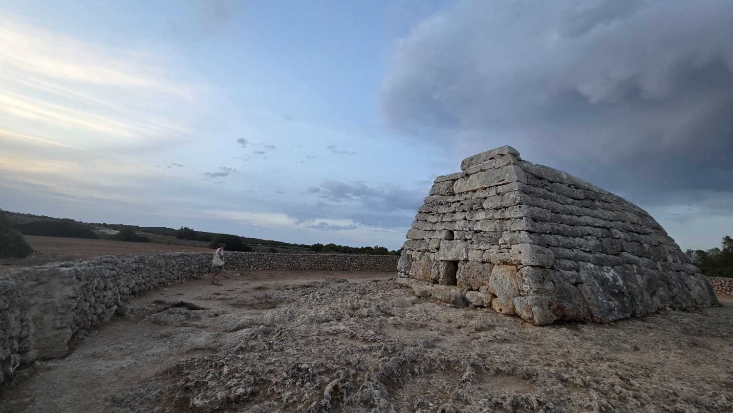 Naveta des Tudons beneath a dramatic Menorcan sky